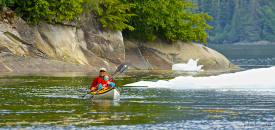 Kayakers enjoy paddling around the icebergs.